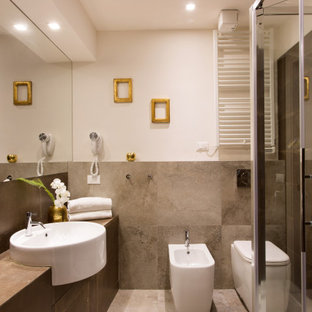 Ispirazione per una stanza da bagno con doccia design di medie dimensioni con ante lisce, ante in legno scuro, doccia ad angolo, WC sospeso, piastrelle grigie, piastrelle in gres porcellanato, pareti bianche, pavimento in gres porcellanato, lavabo a bacinella, top in legno, pavimento grigio, porta doccia a battente, top marrone, un lavabo e mobile bagno incassato
