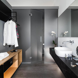 Esempio di una stanza da bagno design con ante nere, lavabo a bacinella, top nero, pareti grigie, pavimento grigio e toilette