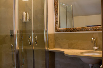 Immagine di una stanza da bagno design con piastrelle beige, lastra di pietra, pareti beige, parquet chiaro e top in marmo