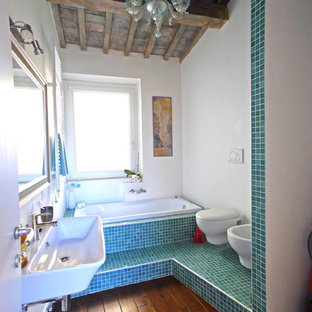 Foto di una stanza da bagno padronale mediterranea con vasca da incasso, piastrelle verdi, piastrelle blu, lavabo sospeso, bidè, pareti bianche, parquet scuro e pavimento marrone