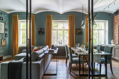 Idee per una sala da pranzo aperta verso il soggiorno chic con pareti blu, pavimento in legno massello medio e pavimento marrone