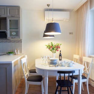 Imagen de comedor de cocina de estilo de casa de campo, de tamaño medio, sin chimenea, con paredes amarillas, suelo de baldosas de cerámica y suelo rosa