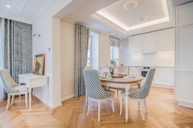 Aménagement d'une salle à manger ouverte sur la cuisine classique avec un mur beige, un sol en bois brun et un sol beige.