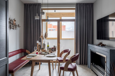 Свежая идея для дизайна: кухня-столовая среднего размера в стиле неоклассика (современная классика) с серыми стенами, горизонтальным камином, полом из керамогранита и бежевым полом - отличное фото интерьера