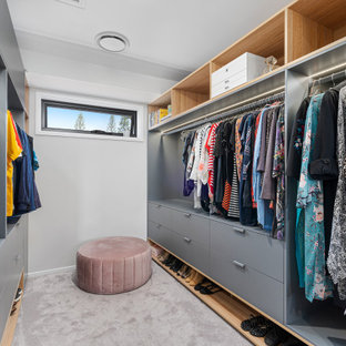 Inspiration for a small contemporary gender-neutral walk-in wardrobe in Gold Coast - Tweed with flat-panel cabinets, grey cabinets, carpet and grey floor.