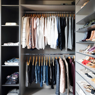 Photo of a large contemporary women's walk-in wardrobe in Melbourne with open cabinets, grey cabinets, carpet and blue floor.