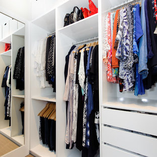 Foto på ett litet funkis walk-in-closet för könsneutrala, med släta luckor, vita skåp, heltäckningsmatta och beiget golv