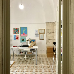 Ispirazione per un atelier mediterraneo di medie dimensioni con pareti bianche, pavimento con piastrelle in ceramica, nessun camino, scrivania autoportante e pavimento multicolore