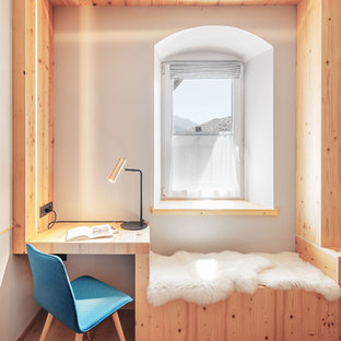 Foto di uno studio minimalista con pareti bianche, pavimento in legno massello medio e scrivania incassata