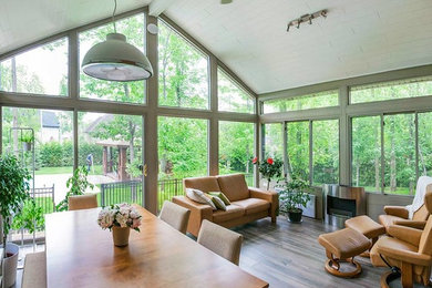 Sunroom - large contemporary medium tone wood floor sunroom idea in New York with a standard fireplace, a metal fireplace and a standard ceiling
