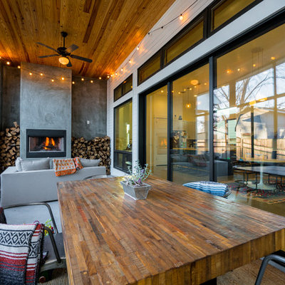 Example of a trendy concrete floor sunroom design in Austin with a standard fireplace and a standard ceiling