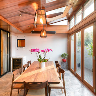 Photo of a transitional sunroom in Sydney with a skylight and grey floor.