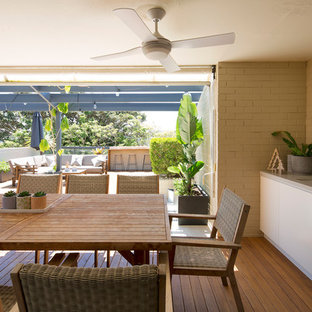 Photo of a contemporary sunroom in Sydney with medium hardwood floors, a standard ceiling and brown floor.