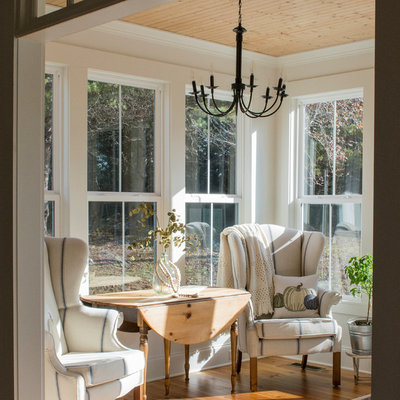 Mid-sized cottage medium tone wood floor and brown floor sunroom photo in Other with a standard ceiling