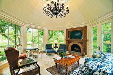 Example of a classic sunroom design in Chicago with a brick fireplace and a skylight