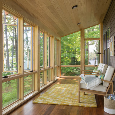 Mid-sized mountain style medium tone wood floor and brown floor sunroom photo in Portland Maine with a standard ceiling
