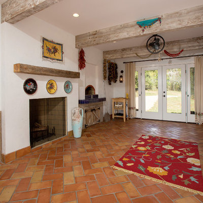Sunroom - mediterranean terra-cotta tile and orange floor sunroom idea in DC Metro with a wood stove, a tile fireplace and a standard ceiling