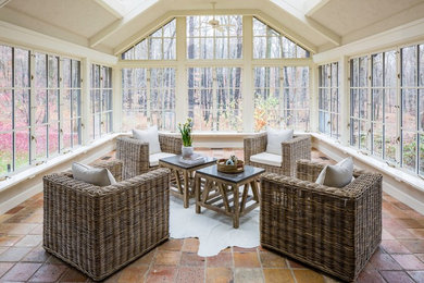 This is an example of a large contemporary conservatory in Other with terracotta flooring, no fireplace, a skylight and orange floors.