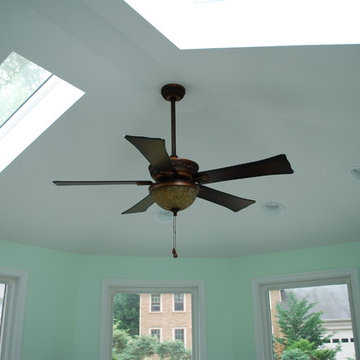 Interior ceiling of sunroom with skylights and ceiling fan.