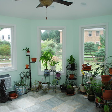 Interior view of unique octagonal sunroom with windows.