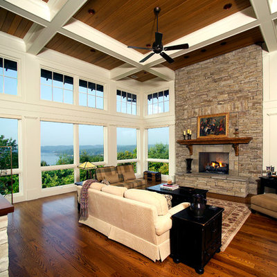 Inspiration for a timeless medium tone wood floor and brown floor sunroom remodel in Other with a standard ceiling and a stone fireplace