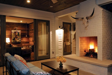 Inspiration for a mid-sized rustic concrete floor and brown floor sunroom remodel in Nashville with a standard fireplace, a brick fireplace and a standard ceiling