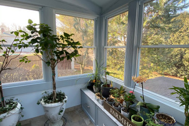 Photo of a medium sized modern conservatory in Other with ceramic flooring, no fireplace, a skylight and grey floors.