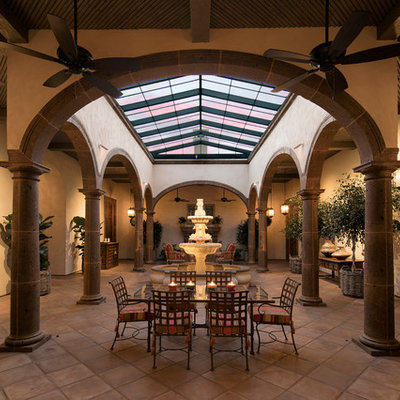 Sunroom - huge mediterranean terra-cotta tile sunroom idea in Santa Barbara with a skylight