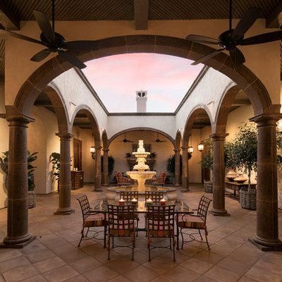 Sunroom - huge mediterranean terra-cotta tile sunroom idea in Santa Barbara