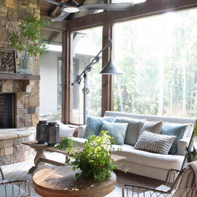 Large cottage sunroom photo in Atlanta with a standard fireplace, a stone fireplace and a standard ceiling