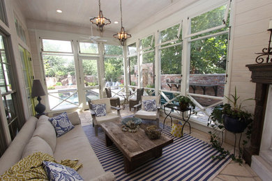Sunroom - mid-sized cottage beige floor sunroom idea in New Orleans with a corner fireplace, a wood fireplace surround and a standard ceiling