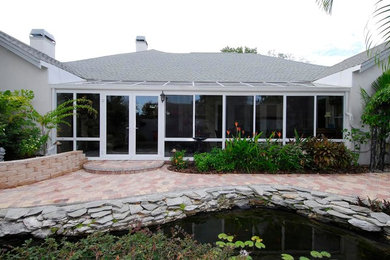 This is an example of a large contemporary conservatory in Chicago with a glass ceiling.
