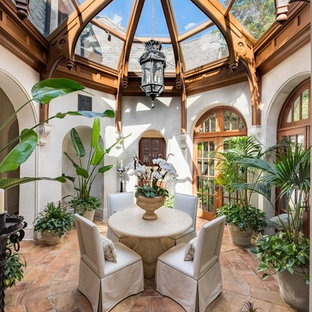Inspiration for a mediterranean conservatory in Atlanta with terracotta flooring, a glass ceiling and brown floors.