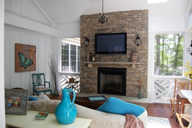 Photo of a large rustic conservatory in Richmond with medium hardwood flooring, a standard fireplace, a stone fireplace surround, a standard ceiling and brown floors.