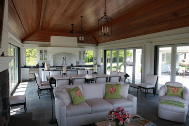 Example of a classic slate floor and blue floor sunroom design in Other with a standard fireplace and a stone fireplace