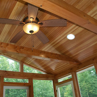 Example of a mid-sized classic medium tone wood floor sunroom design in Manchester with no fireplace and a standard ceiling