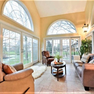 Example of a large classic porcelain tile and beige floor sunroom design in Columbus with no fireplace and a standard ceiling