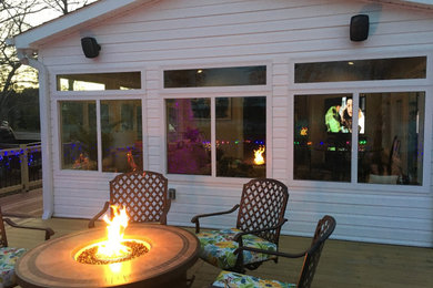 Example of a large eclectic ceramic tile and multicolored floor sunroom design in Other