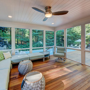 Mid-sized transitional medium tone wood floor sunroom photo in New York with no fireplace and a standard ceiling