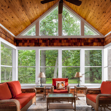 Screen porch features a knotty pine ceiling, cedar shake accents and slate Floor