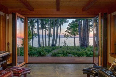 Example of a large arts and crafts concrete floor sunroom design in Seattle