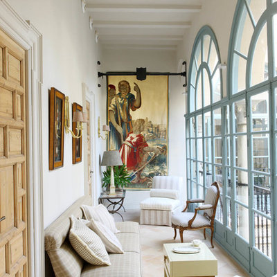 Example of a large tuscan travertine floor sunroom design in Seville with a standard ceiling and no fireplace