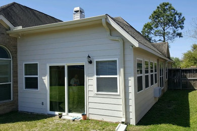 Example of a mid-sized classic medium tone wood floor and gray floor sunroom design in Houston with a standard ceiling