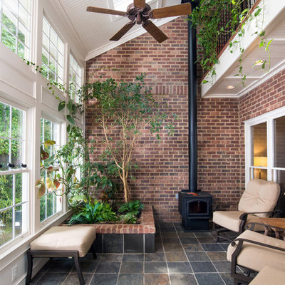 Sunroom - mid-sized traditional ceramic tile and multicolored floor sunroom idea in Atlanta with a wood stove and a skylight
