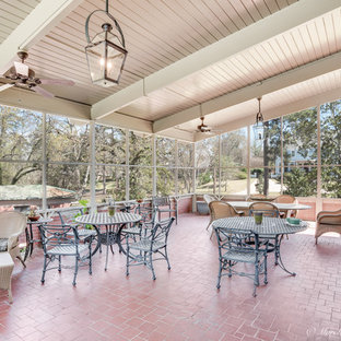 Huge elegant brick floor sunroom photo in New Orleans with no fireplace and a standard ceiling