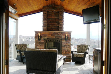 Inspiration for a large transitional concrete floor sunroom remodel in Denver with a standard fireplace, a stone fireplace and a standard ceiling