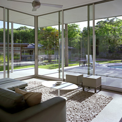 Example of a large minimalist concrete floor and gray floor sunroom design in Austin with no fireplace and a standard ceiling