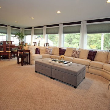 Transitional Sunroom with sectional, custom rug, storage ottoman & window treatm