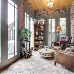 Imagen de galería de estilo americano, de tamaño medio, sin chimenea, con techo estándar, suelo beige y suelo de cemento