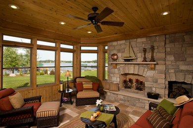 Example of a mid-sized classic travertine floor sunroom design with a standard fireplace, a stone fireplace and a standard ceiling